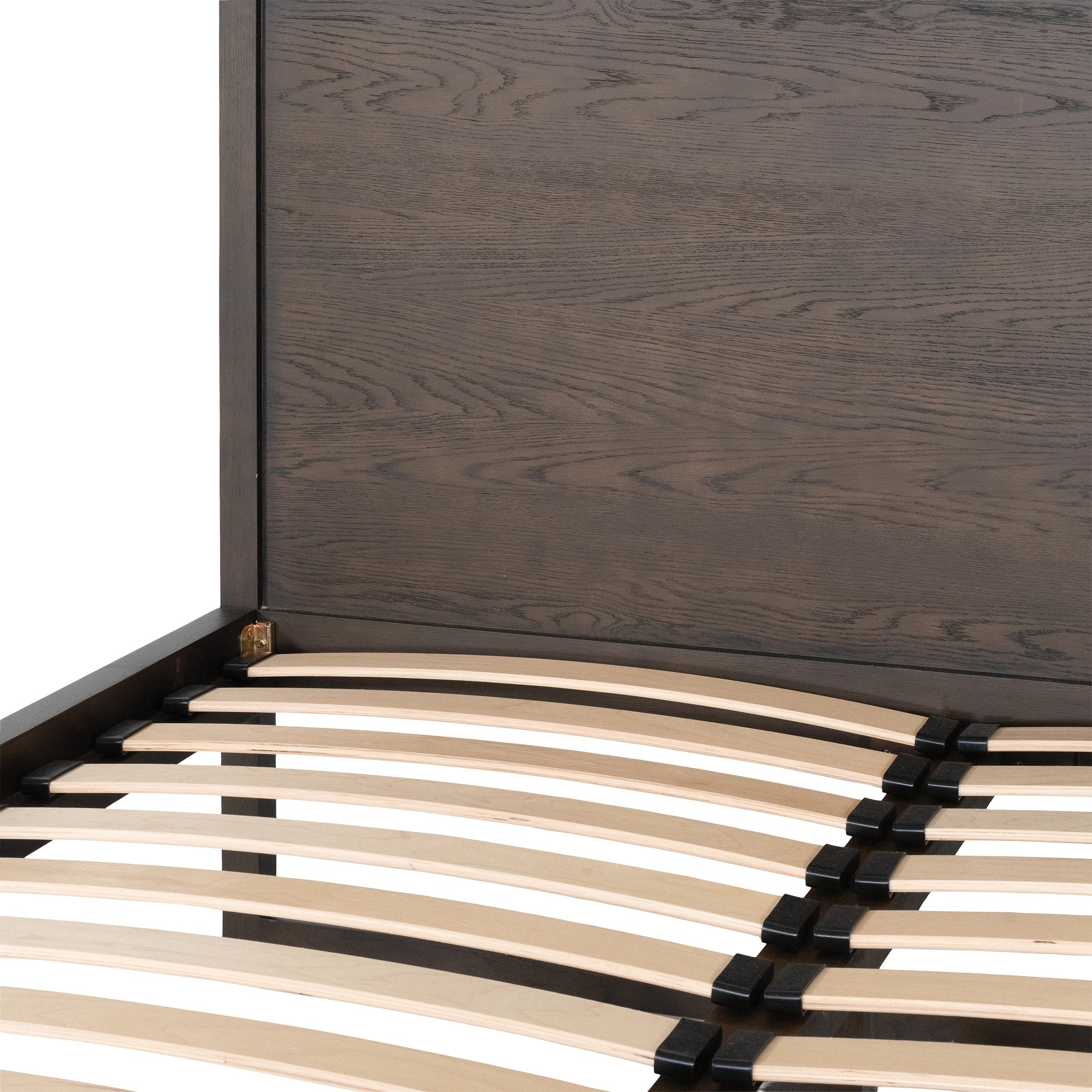 A sleek modern bed frame crafted from dark oak, featuring a minimalist open-base design. The bed is styled with crisp white linen and plush pillows, offering a refined and contemporary bedroom aesthetic