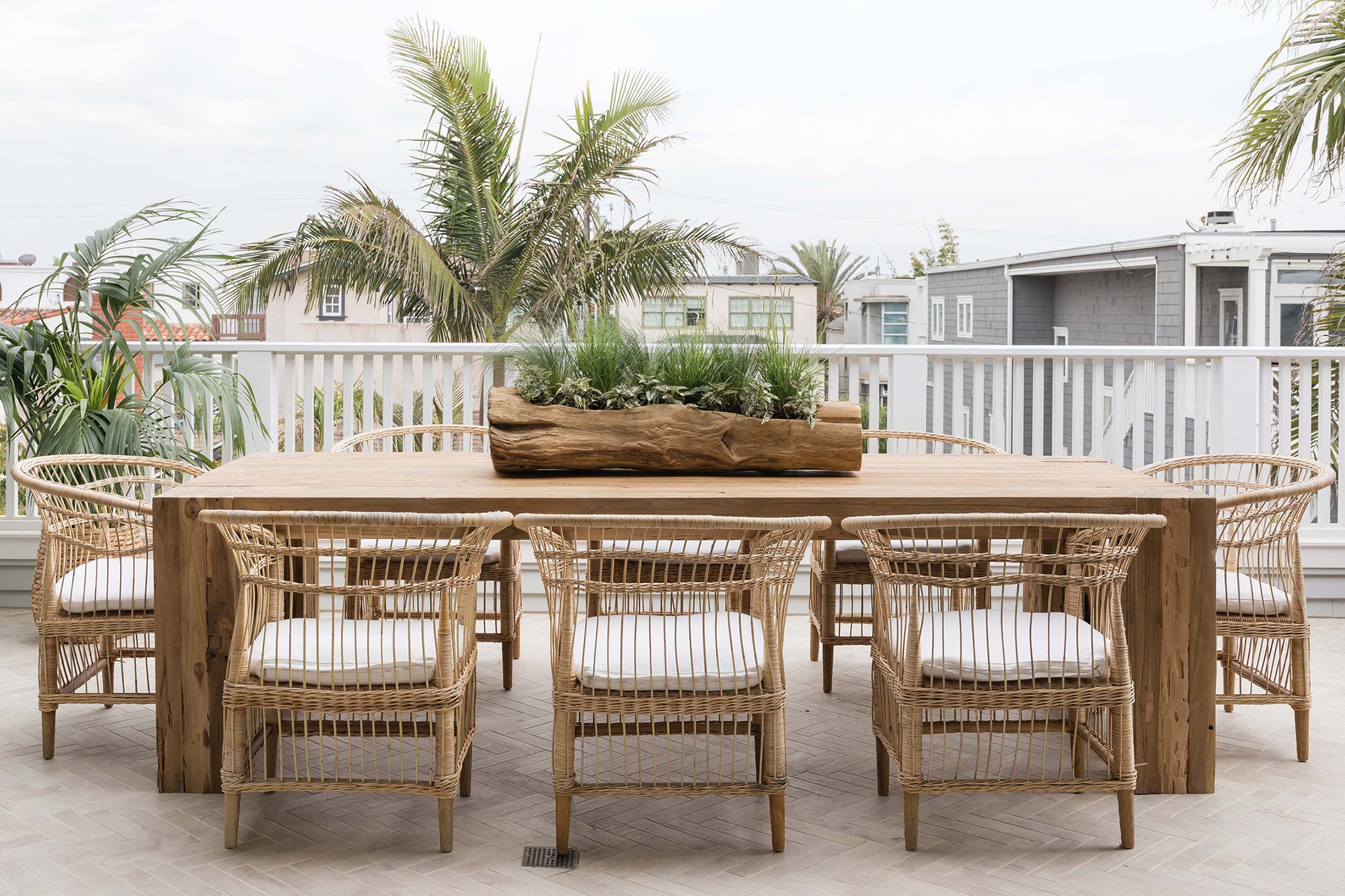Nakula rattan dining chairs styled around a timber outdoor table in a relaxed mediterranean inspired australian setting