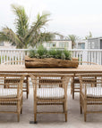 Nakula rattan dining chairs styled around a timber outdoor table in a relaxed mediterranean inspired australian setting