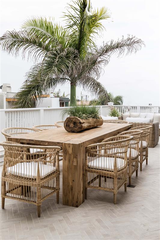 Nakula rattan dining chairs styled around a timber outdoor table in a relaxed mediterranean inspired australian setting
