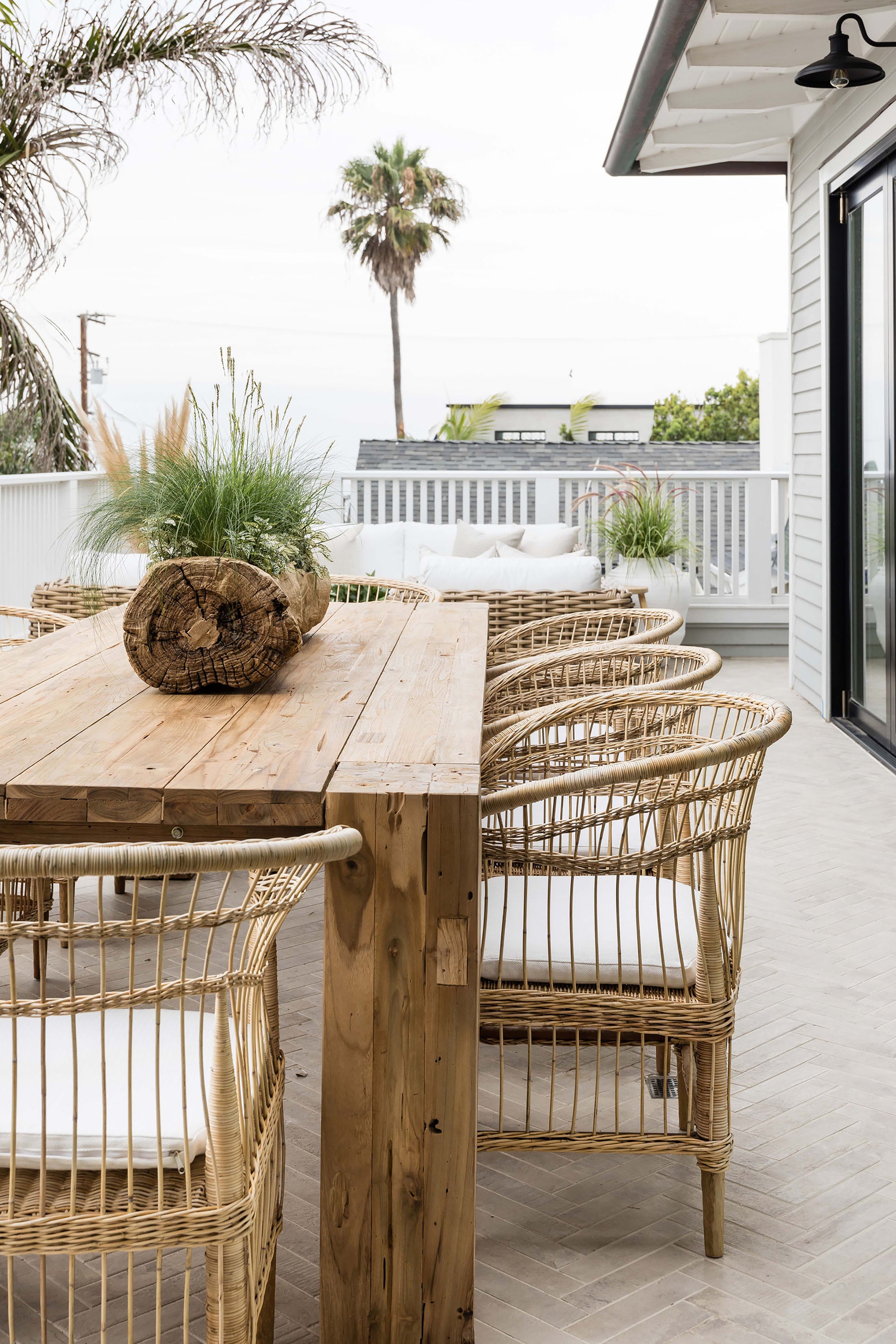 Nakula rattan dining chairs styled around a timber outdoor table in a relaxed mediterranean inspired australian setting