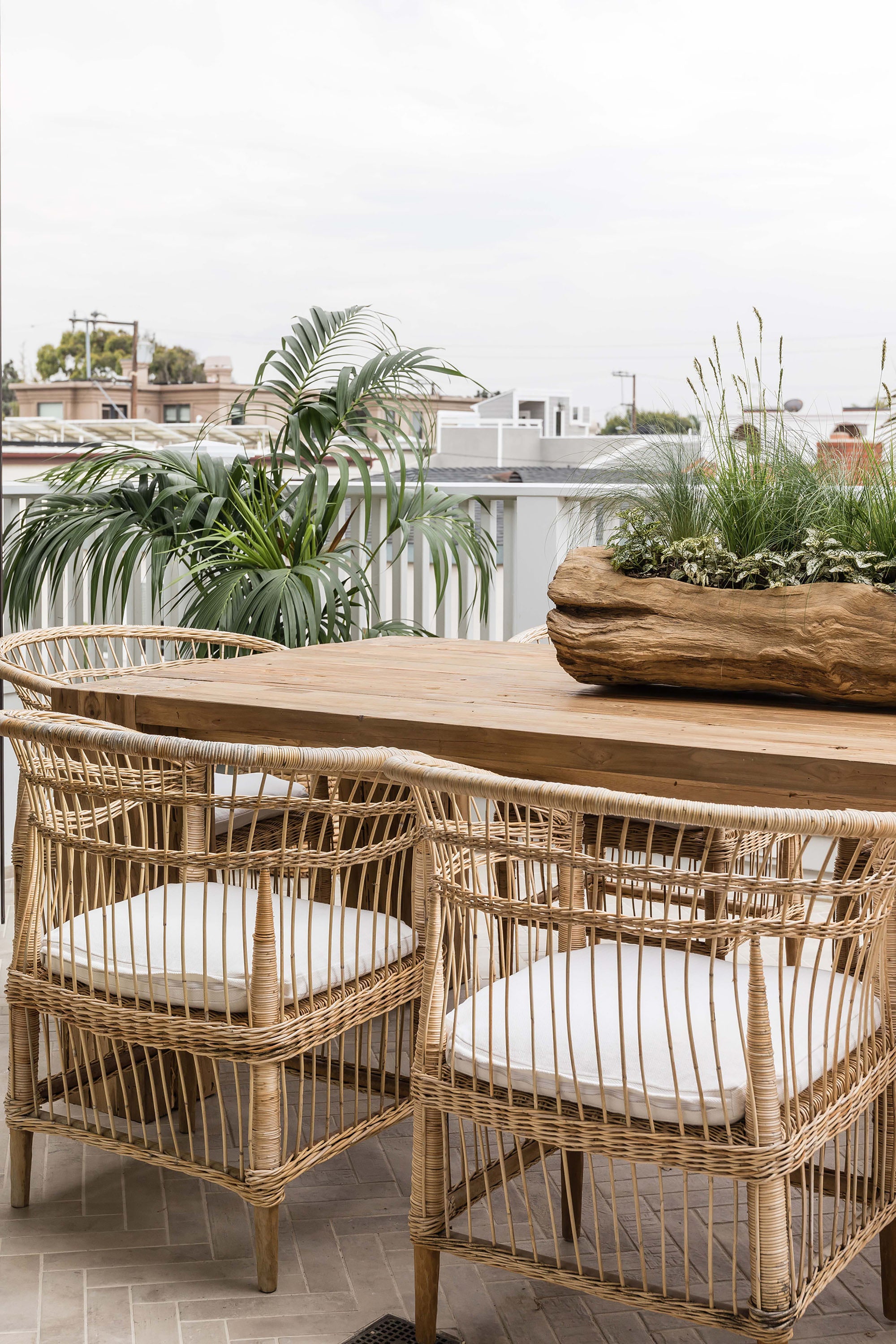 Nakula rattan dining chairs styled around a timber outdoor table in a relaxed mediterranean inspired australian setting
