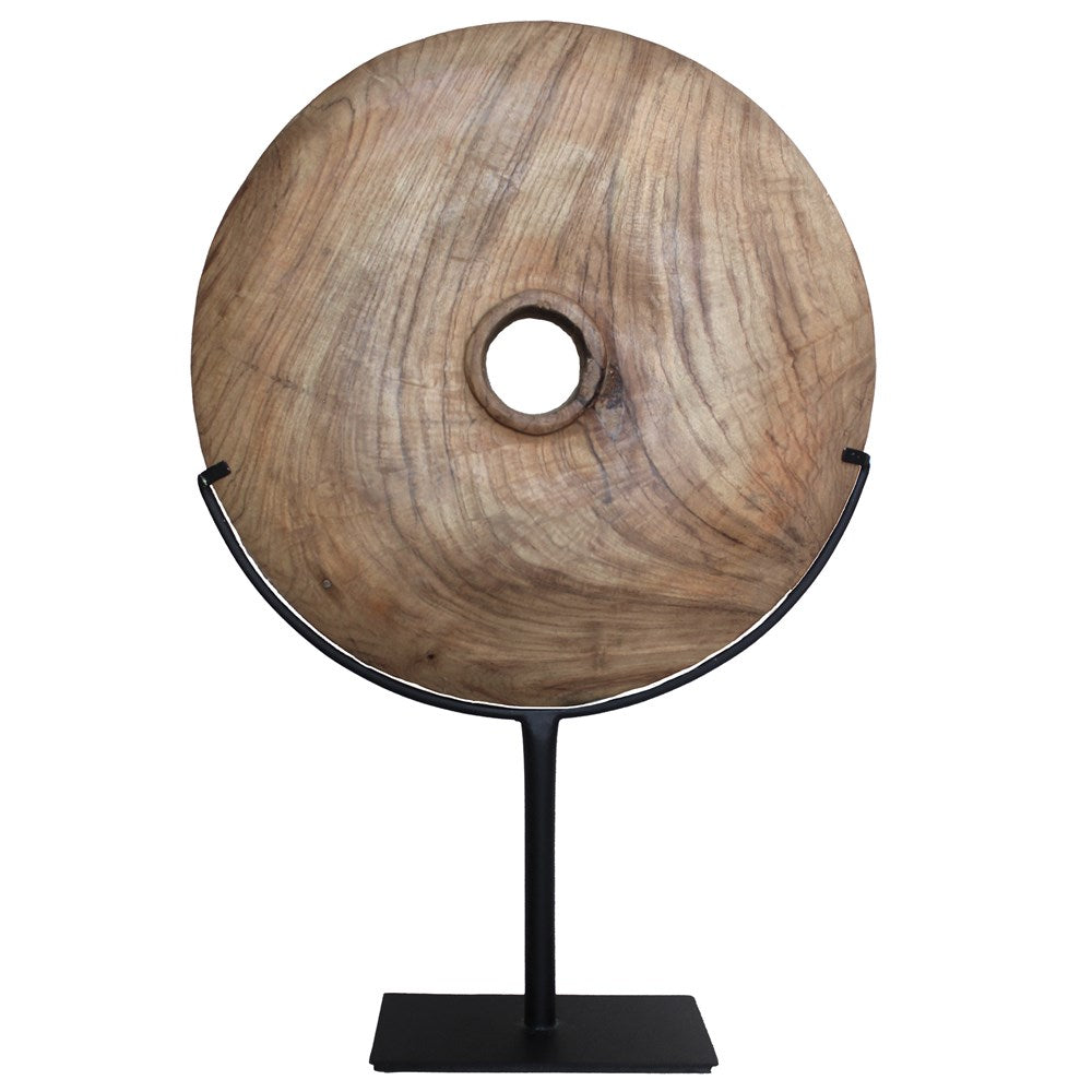 Natural carved teak disc sculpture with stand in modern minimalist design, perfect for adding bold decorative accents to any interior space