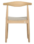 Kulala Living natural wood dining chair featuring a sculpted backrest and a lightly upholstered seat in a neutral fabric. A blend of minimalist design and organic materials, perfect for modern dining spaces.
