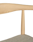 Kulala Living natural wood dining chair featuring a sculpted backrest and a lightly upholstered seat in a neutral fabric. A blend of minimalist design and organic materials, perfect for modern dining spaces.