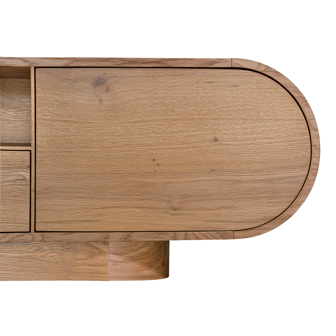 Natural oak TV unit featuring a sleek curved design with ample storage, including cabinets, a drawer, and an open shelf for media organisation