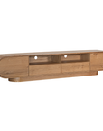 Natural oak TV unit featuring a sleek curved design with ample storage, including cabinets, a drawer, and an open shelf for media organisation