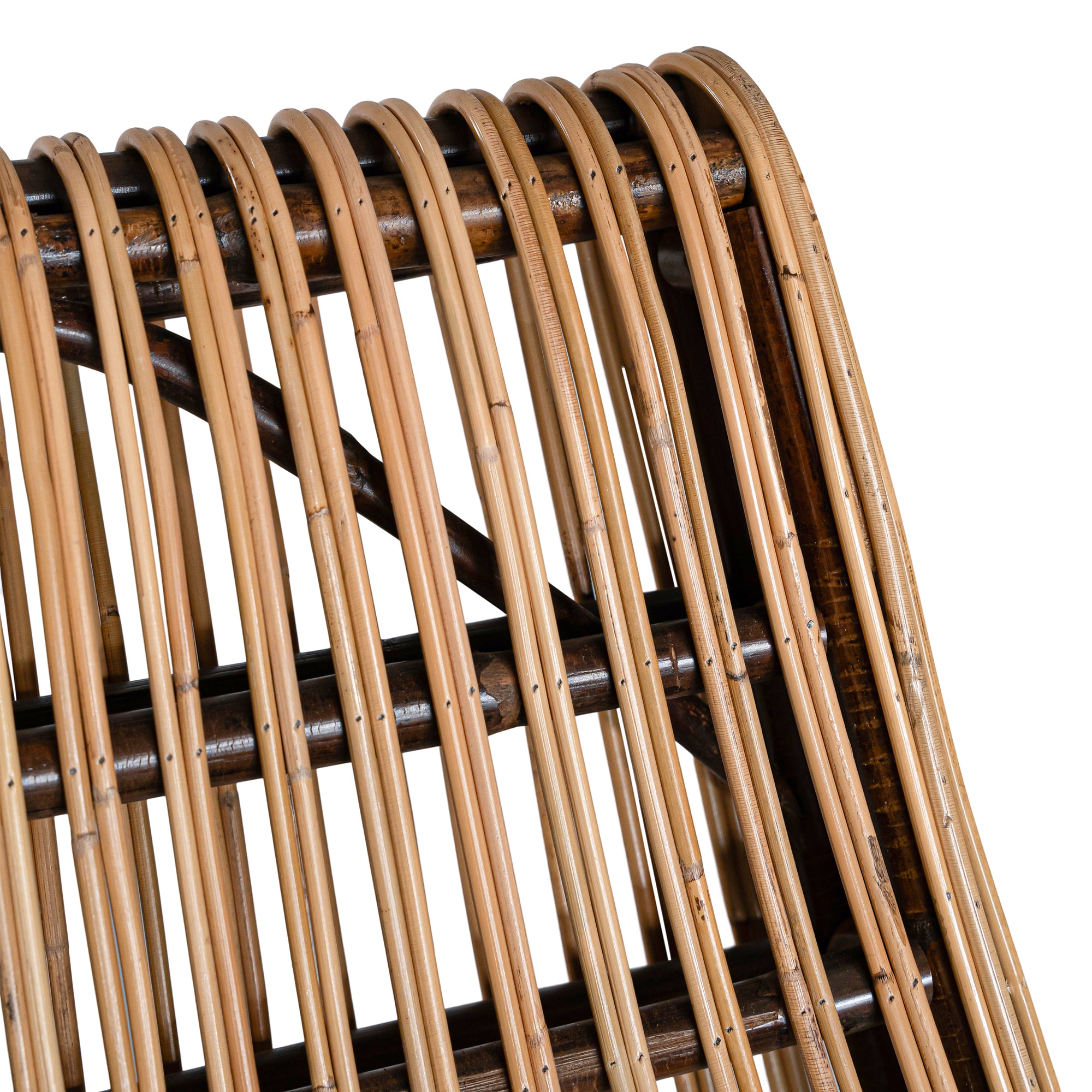 A sculptural natural rattan lounge chair with a curved, low-profile silhouette and sleek wooden legs. The woven design adds texture, while the deep seat and ergonomic shape offer comfort and relaxation.