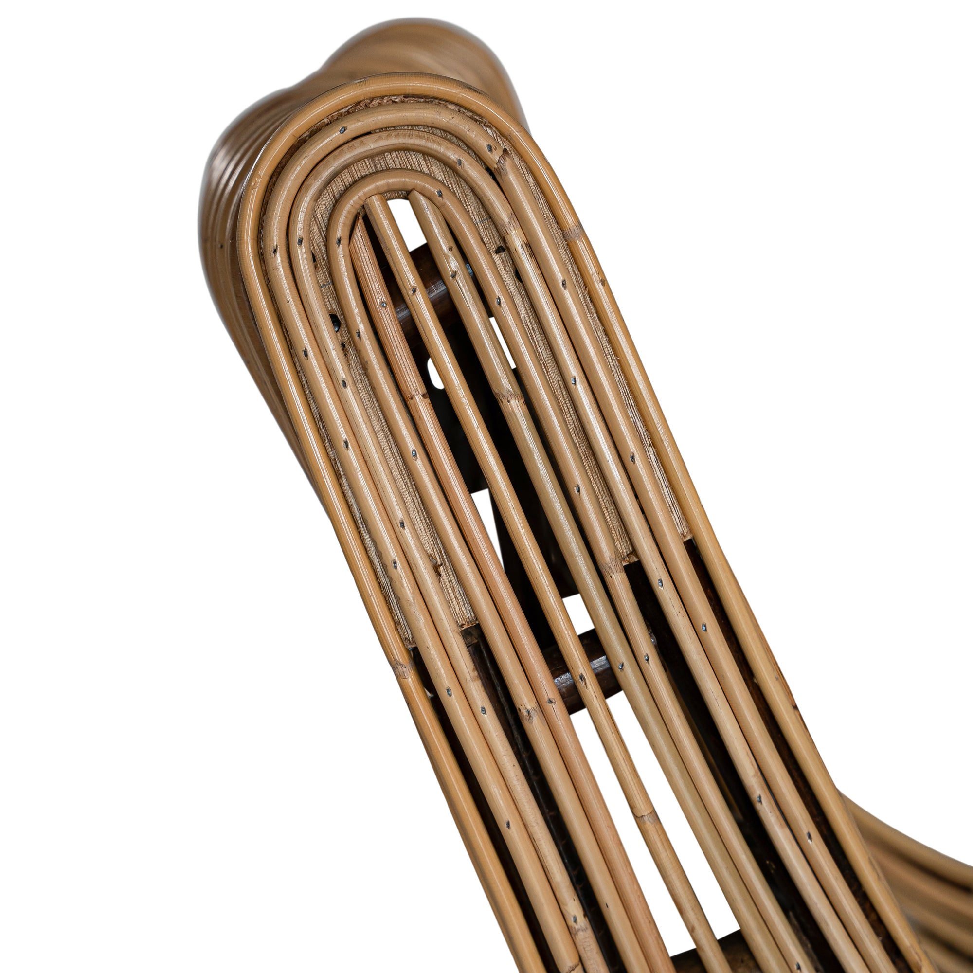 A sculptural natural rattan lounge chair with a curved, low-profile silhouette and sleek wooden legs. The woven design adds texture, while the deep seat and ergonomic shape offer comfort and relaxation