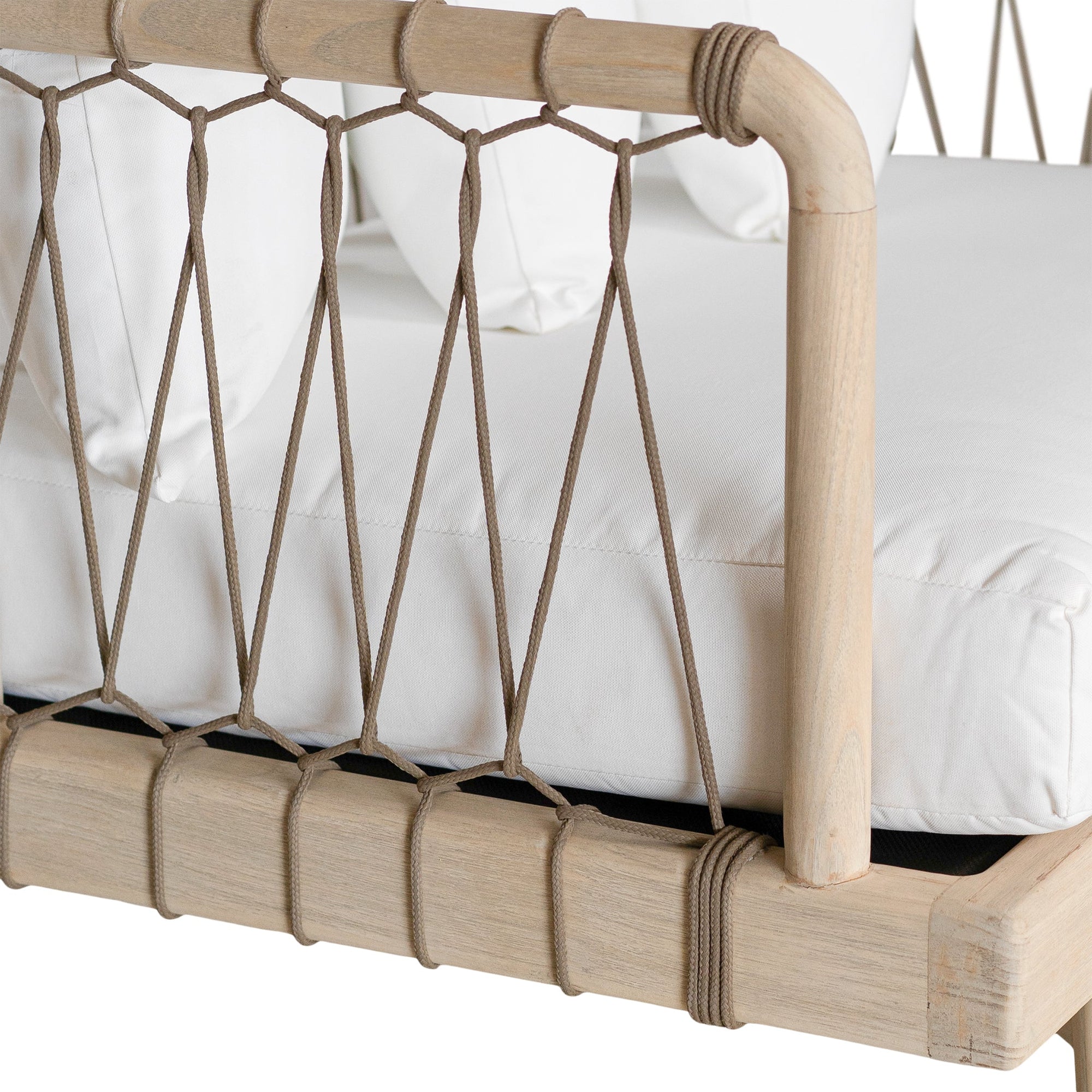 Natural rope lounge chair with white cushions, featuring a light timber frame and modern coastal aesthetic.
