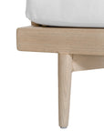 Natural rope lounge chair with white cushions, featuring a light timber frame and modern coastal aesthetic.