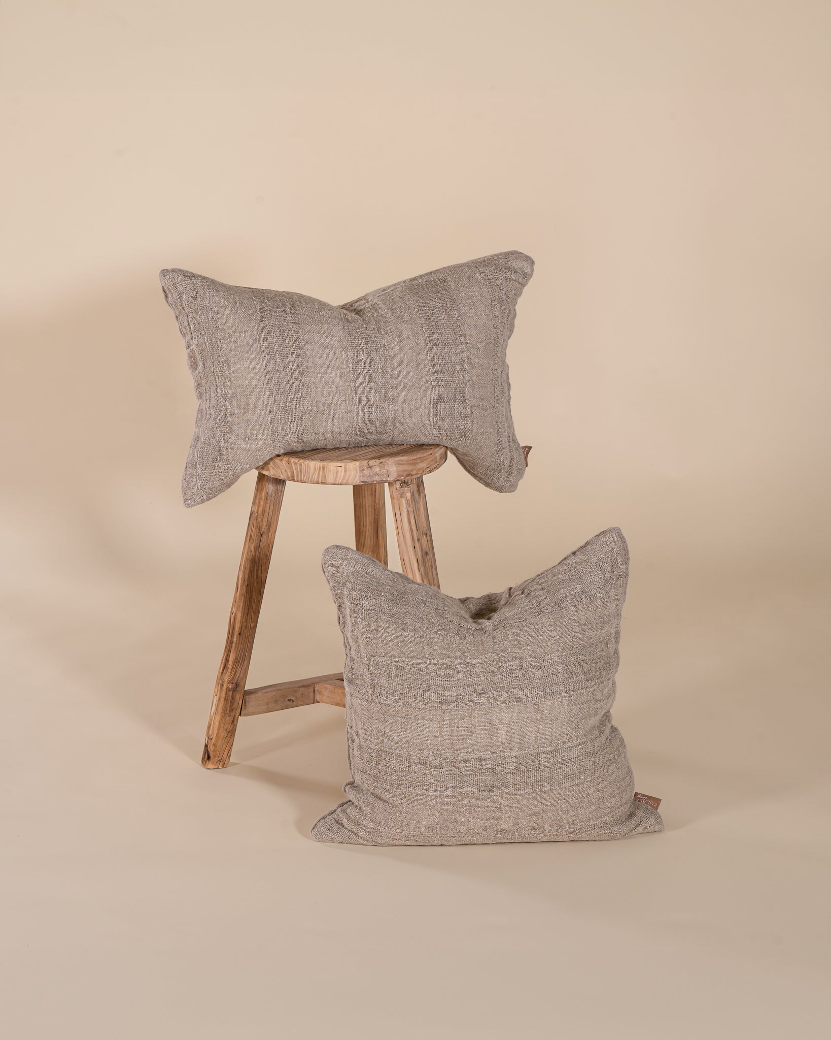 Natural linen cushion with a textured finish in a soft, neutral tone, perfect for adding warmth and comfort to any living space