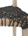 Natural timber dining chair with a black woven seat, showcasing rustic craftsmanship and contemporary design