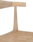 Natural timber dining chair with woven cane seat and curved backrest, ideal for relaxed, coastal-inspired dining spaces