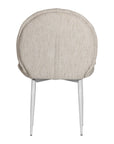 Contemporary natural upholstered dining chair with a plush, rounded backrest and cushioned seat, supported by sleek black metal legs for a sophisticated modern look