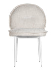 Contemporary natural upholstered dining chair with a plush, rounded backrest and cushioned seat, supported by sleek black metal legs for a sophisticated modern look