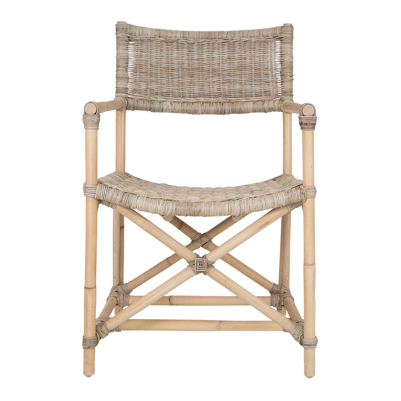 Natural wicker armchair with armrests and a sturdy cross-frame base, showcasing a contemporary design suitable for indoor or outdoor dining spaces.