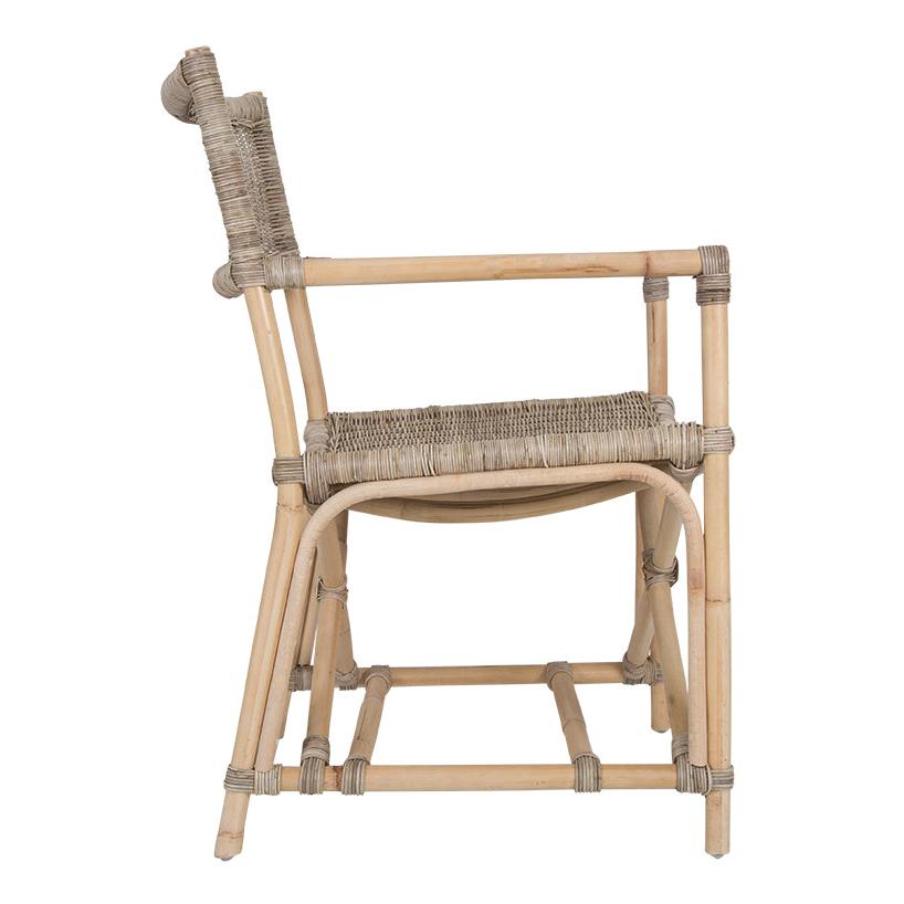 Natural wicker armchair with armrests and a sturdy cross-frame base, showcasing a contemporary design suitable for indoor or outdoor dining spaces.