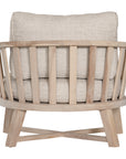 Nikki Beach Occasional Chair with natural timber frame and neutral upholstered cushions, showcasing a modern coastal design