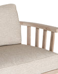 Nikki Beach Occasional Chair with natural timber frame and neutral upholstered cushions, showcasing a modern coastal design