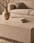 Nulusi coffee table in dune hydro dipped finish with rectangular block form styled in a warm neutral living space.