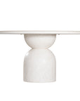 Nuru dining table in eggshell finish with round stone top and sculptural pedestal base isolated on a light background