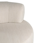 A contemporary pebble upholstered lounge chair with a low-profile design and curved backrest. This modern, armless seating piece features a smooth, rounded silhouette, making it a stylish and comfortable addition to any living space