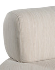 A contemporary pebble upholstered lounge chair with a low-profile design and curved backrest. This modern, armless seating piece features a smooth, rounded silhouette, making it a stylish and comfortable addition to any living space