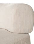 A contemporary pebble upholstered lounge chair with a low-profile design and curved backrest. This modern, armless seating piece features a smooth, rounded silhouette, making it a stylish and comfortable addition to any living space