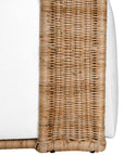 A rattan armchair featuring a curved backrest and a plush white upholstered seat. This coastal-inspired piece combines natural textures with modern comfort, ideal for relaxed living spaces