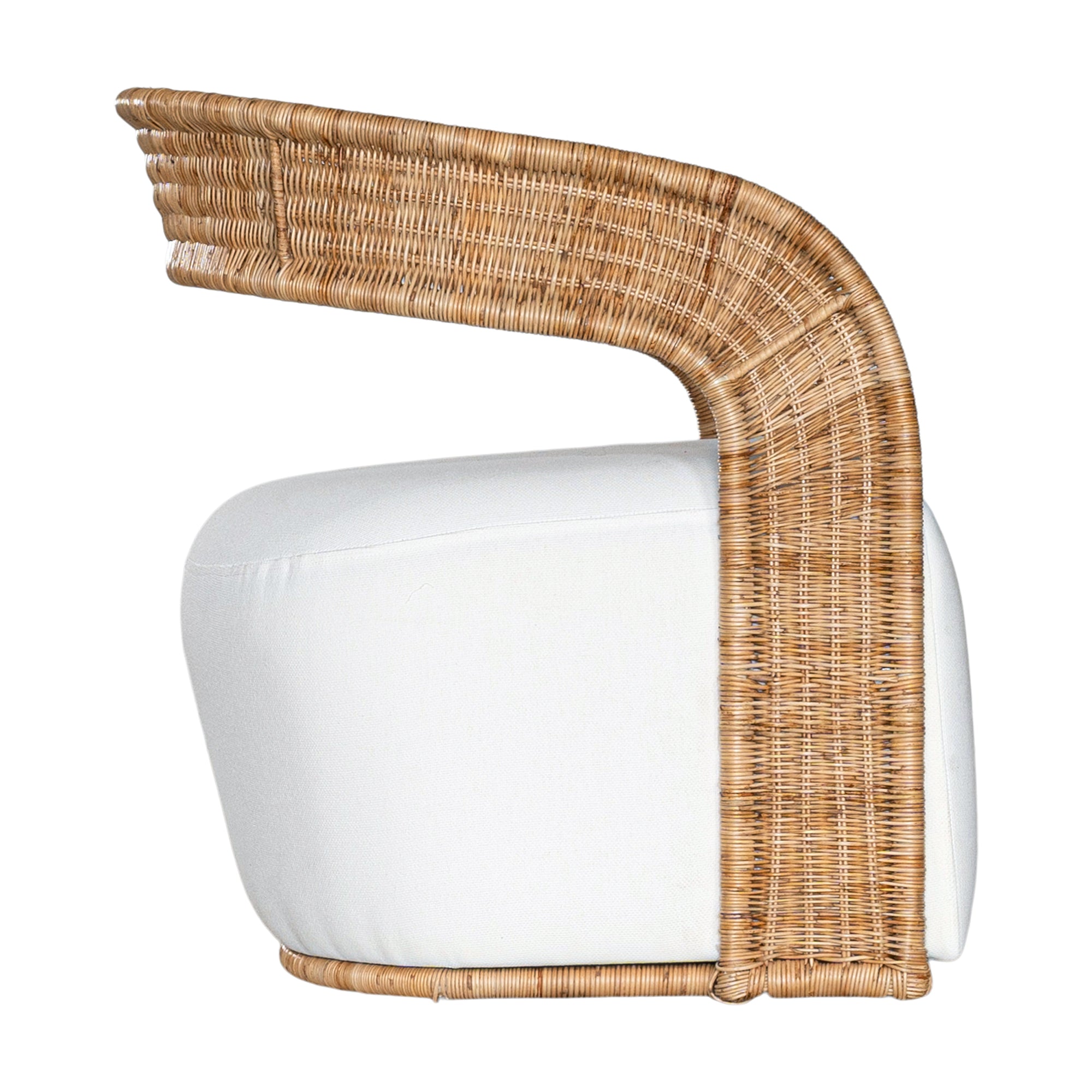 A rattan armchair featuring a curved backrest and a plush white upholstered seat. This coastal-inspired piece combines natural textures with modern comfort, ideal for relaxed living spaces