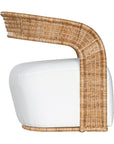 A rattan armchair featuring a curved backrest and a plush white upholstered seat. This coastal-inspired piece combines natural textures with modern comfort, ideal for relaxed living spaces