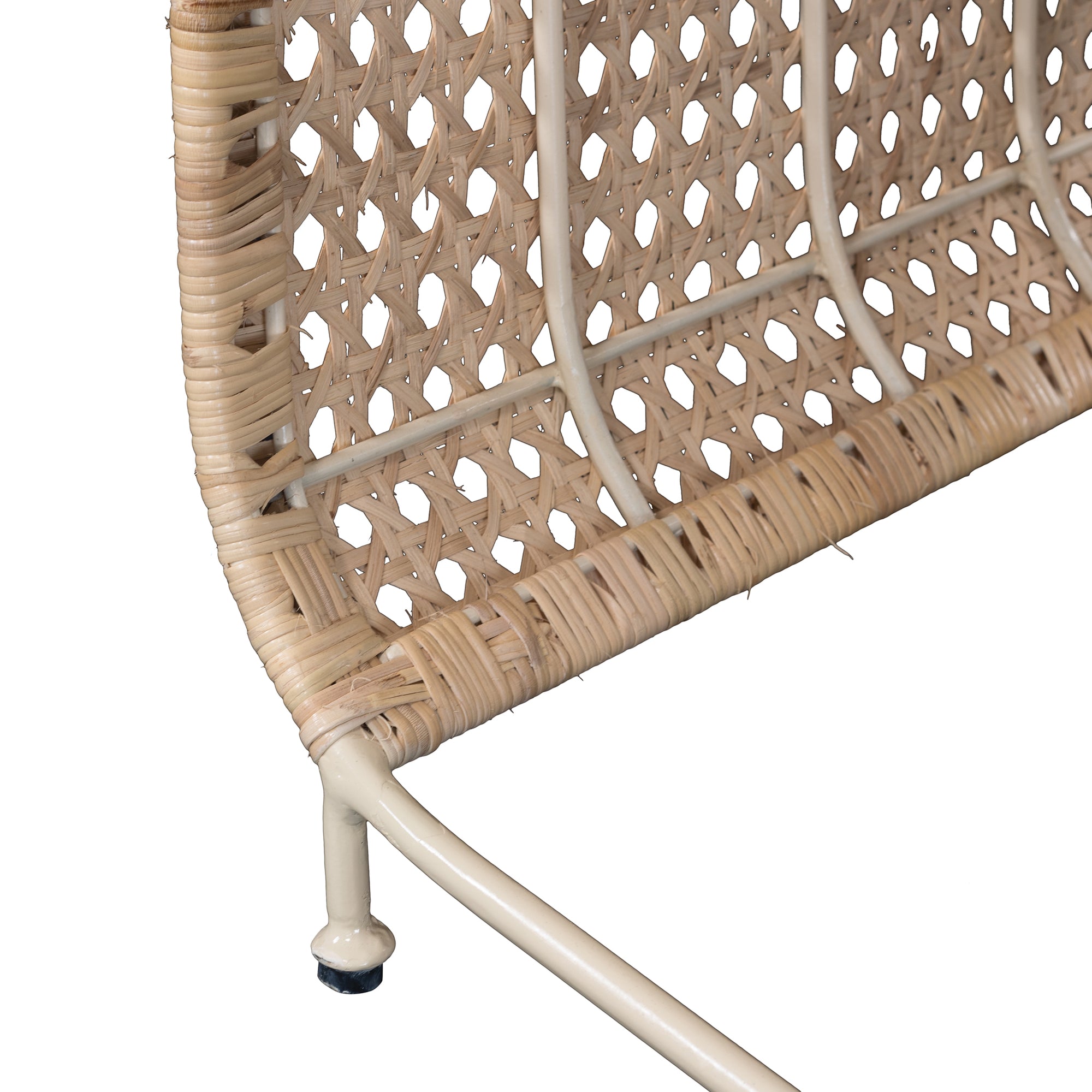 Modern coastal rattan lounge chair with curved silhouette and open weave pattern, featuring a natural finish and sleek white metal frame