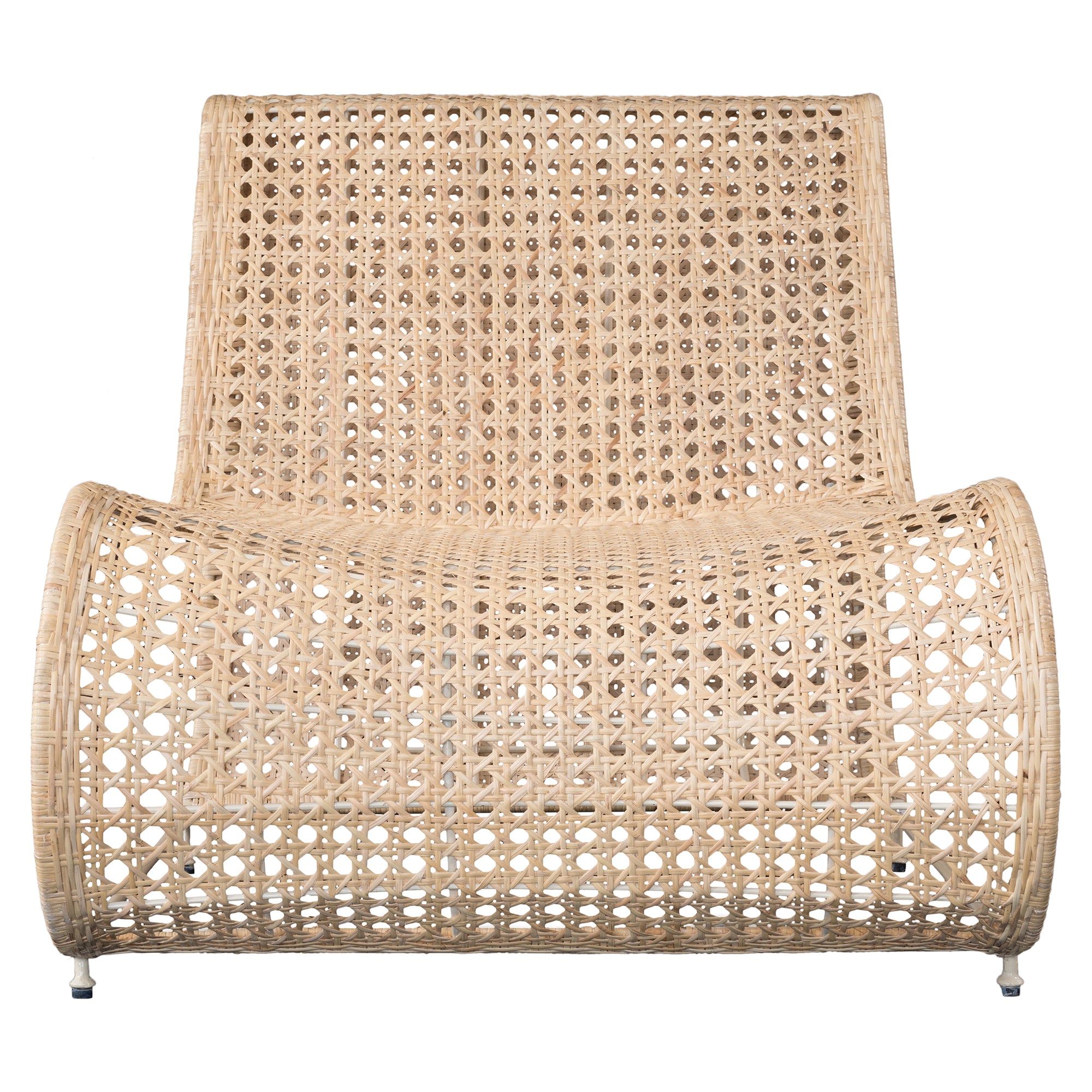 Modern coastal rattan lounge chair with curved silhouette and open weave pattern, featuring a natural finish and sleek white metal frame