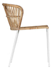 Modern rattan dining chair with a white metal frame, featuring a curved backrest and woven natural rattan for a stylish and airy aesthetic