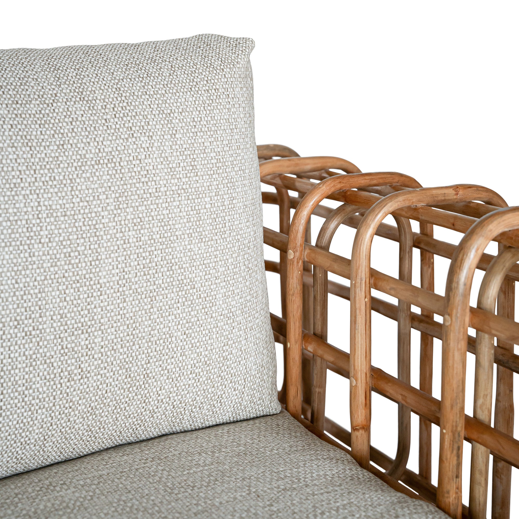 Handcrafted rattan two seater sofa featuring an intricate open-weave frame with plush natural cushions, combining natural texture with contemporary comfort for indoor or covered outdoor spaces