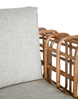 Handcrafted rattan two seater sofa featuring an intricate open-weave frame with plush natural cushions, combining natural texture with contemporary comfort for indoor or covered outdoor spaces