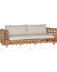 Handcrafted rattan two seater sofa featuring an intricate open-weave frame with plush natural cushions, combining natural texture with contemporary comfort for indoor or covered outdoor spaces