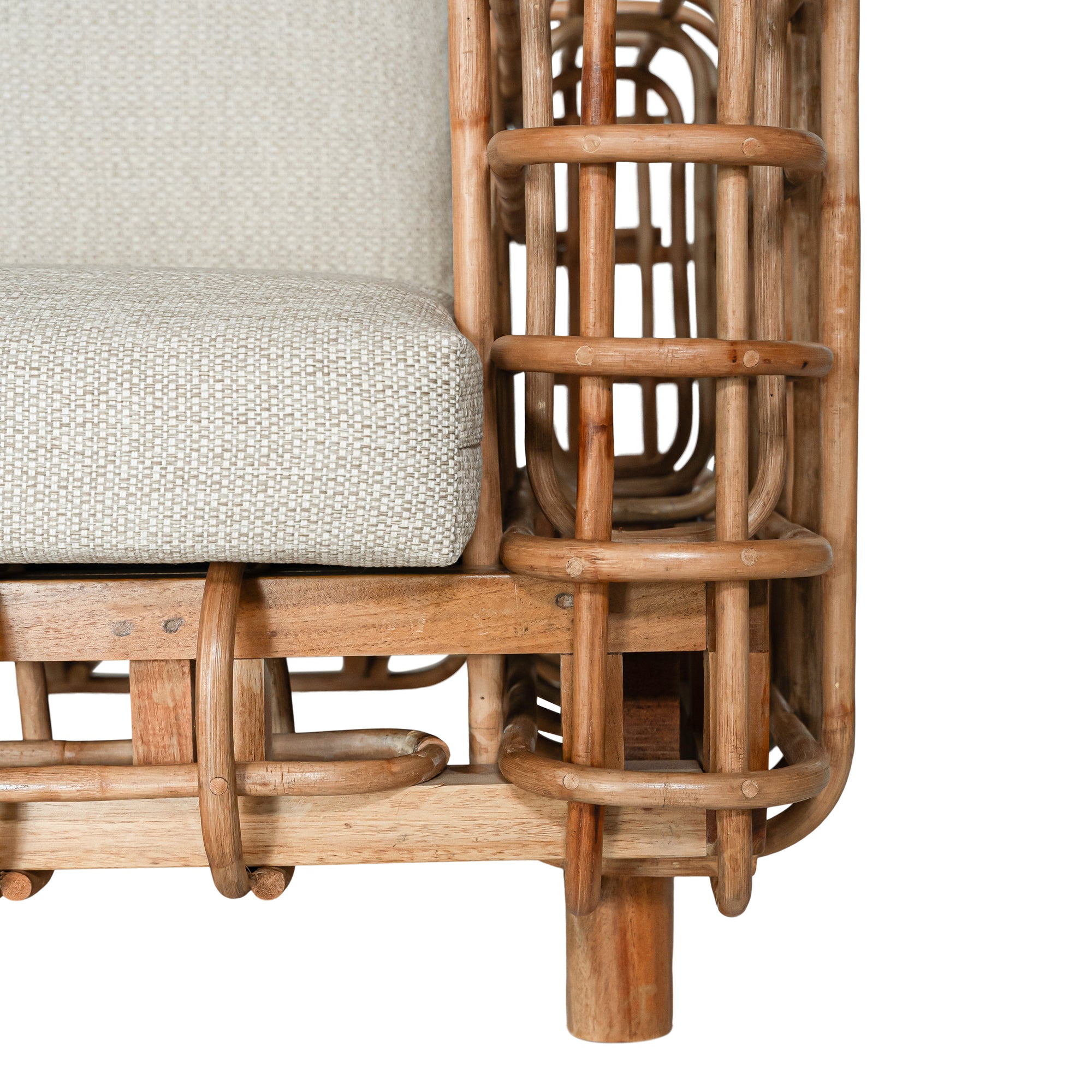 Handcrafted rattan two seater sofa featuring an intricate open-weave frame with plush natural cushions, combining natural texture with contemporary comfort for indoor or covered outdoor spaces