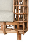 Handcrafted rattan two seater sofa featuring an intricate open-weave frame with plush natural cushions, combining natural texture with contemporary comfort for indoor or covered outdoor spaces