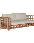 Handcrafted rattan two seater sofa featuring an intricate open-weave frame with plush natural cushions, combining natural texture with contemporary comfort for indoor or covered outdoor spaces