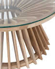 A stylish round dining table featuring a sculptural wooden base with a clear glass top, offering a contemporary yet natural aesthetic for modern dining spaces.