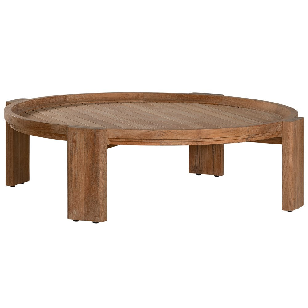 The Kulala Living Round Teak Coffee Table, crafted from solid teak with a slatted tabletop and sturdy block legs. This timeless design adds warmth and natural texture to any living space