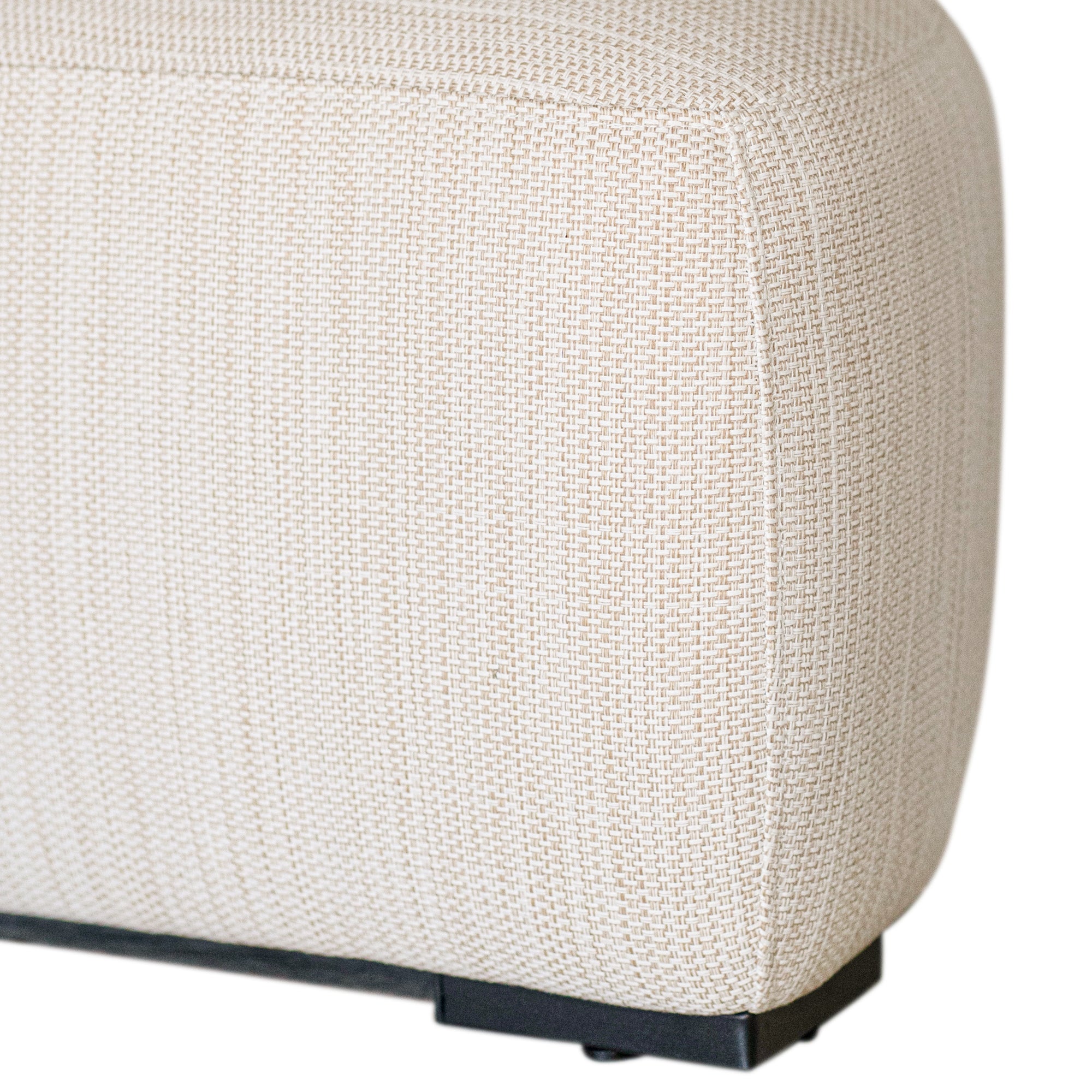 Curved upholstered ottoman with natural textured fabric and subtle black feet, ideal for contemporary living spaces