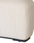 Curved upholstered ottoman with natural textured fabric and subtle black feet, ideal for contemporary living spaces