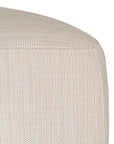 Curved upholstered ottoman with natural textured fabric and subtle black feet, ideal for contemporary living spaces