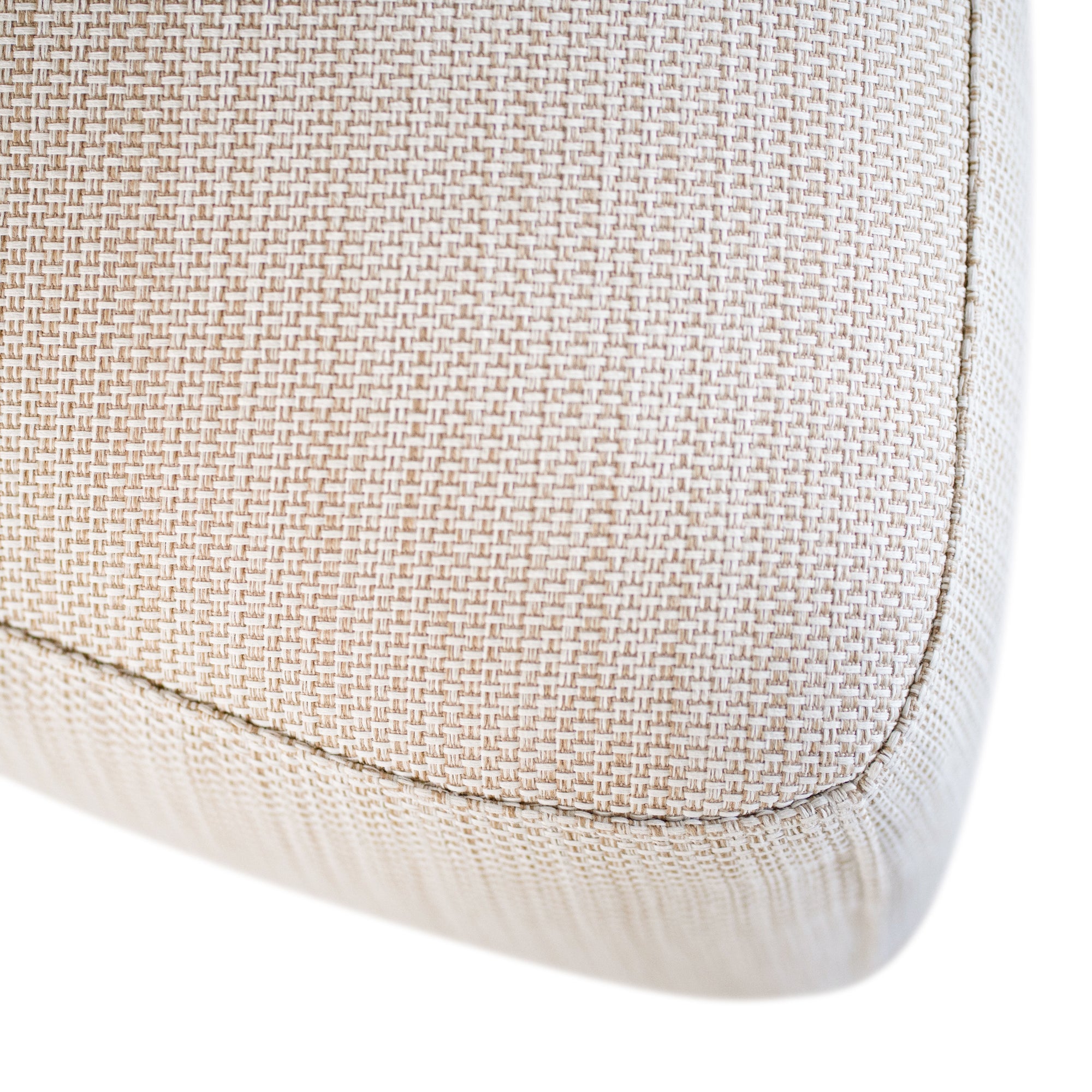 Curved upholstered ottoman with natural textured fabric and subtle black feet, ideal for contemporary living spaces