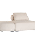 Curved upholstered ottoman with natural textured fabric and subtle black feet, ideal for contemporary living spaces