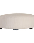 Curved upholstered ottoman with natural textured fabric and subtle black feet, ideal for contemporary living spaces