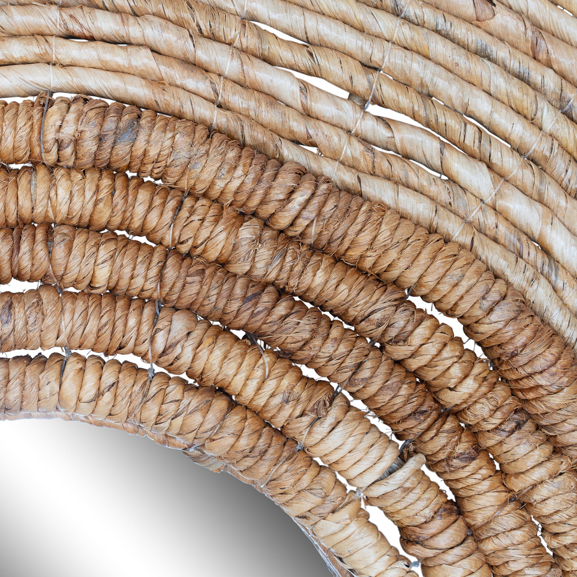 Round woven wall mirror with natural fibre frame, ideal for adding a coastal and rustic touch to interior spaces